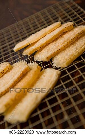 Stock Image - parmesan cheese rind puffs snack.. Fotosearch
