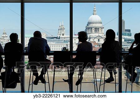 People sit looking at the London skyline from the 3rd floor cafe at Tate Modern art gallery, London, England. View Large Photo Image Stock Image - People sit looking at the London skyline from the 3rd floor cafe at Tate Modern art gallery, London, England.. Fotosearch