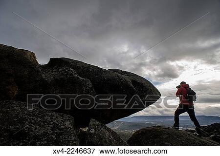 Stock Photo - Photographer silhouette at Pedriza Nature area, Madrid Province, Spain.. Fotosearch