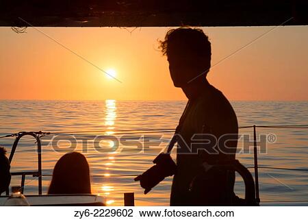 Photographer silhouette sunrise. Dolphin watch sunrise tour, Cala Ratjada, Mallorca, Balearic islands, Spain in July. View Large Photo Image Stock Image - Photographer silhouette sunrise. Dolphin watch sunrise tour, Cala Ratjada, Mallorca, Balearic islands, Spain in July.. Fotosearch