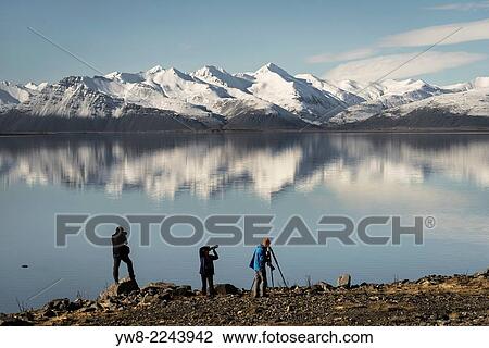 Stock Image - Photographers photographing the landscape, Hvalsnes, Eastern, Iceland.. Fotosearch