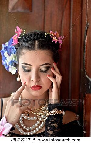 Stock Photography - Portrait of a Latin woman inspired by the figure of Mexican painter Frieda Kahlo.. Fotosearch