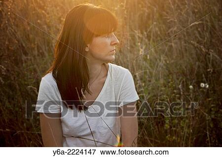 Portrait of a mid adult woman in field. View Large Photo Image Stock Photo - Portrait of a mid adult woman in field.. Fotosearch