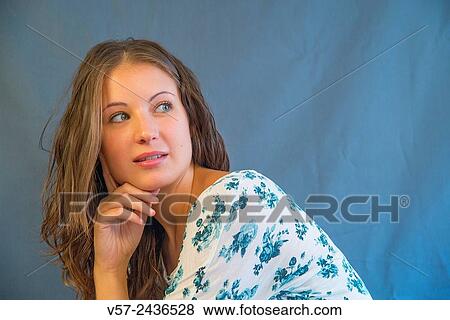 Portrait of young woman looking back, hand on chin. View Large Photo Image Stock Photo - Portrait of young woman looking back, hand on chin.. Fotosearch