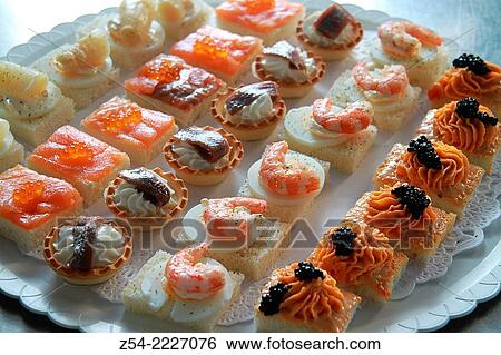 Stock Photograph - Prawn, anchovy, pink salmon, asparagus, caviar canapes.. Fotosearch