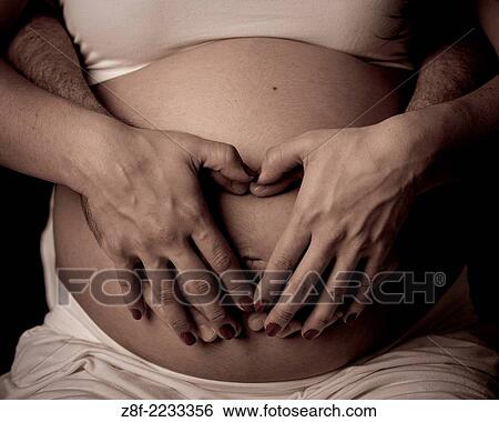 Stock Photograph - pregnant woman with husband.. Fotosearch