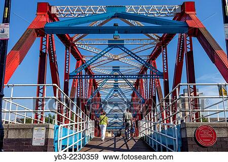 Red Iron Footbridge, Salford Quays, Manchester, England. View Large Photo Image Stock Photo - Red Iron Footbridge, Salford Quays, Manchester, England.. Fotosearch