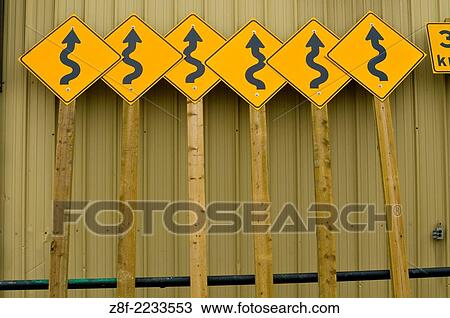 Roadside curve signs leaning on public works building. View Large Photo Image Stock Image - Roadside curve signs leaning on public works building.. Fotosearch