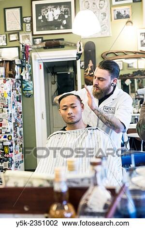 Rotterdam, Netherlands. Barber store Schorem. Barber helping his customer in his barber shop by cutting and modeling his hair. View Large Photo Image Stock Image - Rotterdam, Netherlands. Barber store Schorem. Barber helping his customer in his barber shop by cutting and modeling his hair.. Fotosearch
