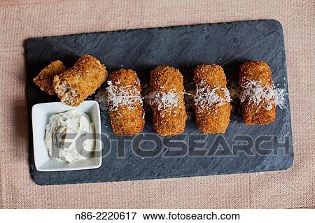 Stock Photo - salmon croquettes and tarter sauce.. Fotosearch