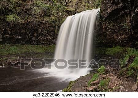 Sgwd yr Eira Waterfall - River Hepste, near Ystradfellte, Brecon Beacons national park, Wales. View Large Photo Image Stock Photograph - Sgwd yr Eira Waterfall - River Hepste, near Ystradfellte, Brecon Beacons national park, Wales.. Fotosearch