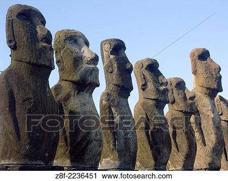 Stock Image - Silent sentinels. Some of the 15 moai (ancestral spirit figures) at Ahu Tongariki, Easter Island, Chile.. Fotosearch