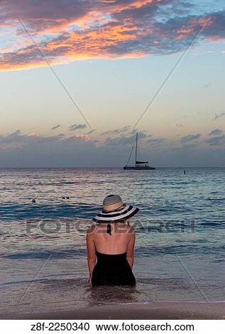 Sitting on beach in sunset. View Large Photo Image Stock Image - Sitting on beach in sunset.. Fotosearch