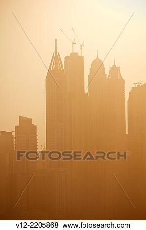 Skyscrapers from The Dubai Fountain, Dubai, United Arab Emirates at sunset View Large Photo Image Stock Photo - Skyscrapers from The Dubai Fountain, Dubai, United Arab Emirates at sunset. Fotosearch