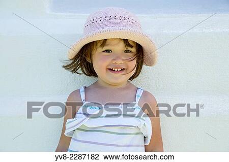 Smiling toddler girl wearing a summer hat. View Large Photo Image Stock Image - Smiling toddler girl wearing a summer hat.. Fotosearch