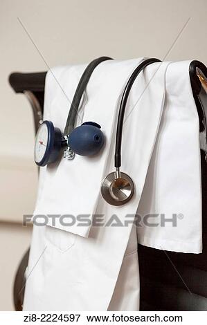 Stock Photo - Stethoscope, blood pressure monitor and white coat in doctors office.. Fotosearch