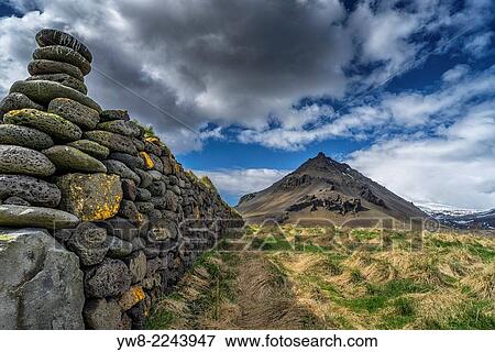 Stock Photo - Stone wall, Mt Stapafell in the background, Snaefellsnes Peninsula, Iceland.. Fotosearch