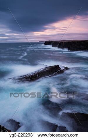 Stormy seas crash against dramatic coastal cliffs at Yesnaby, Orkney, Scotland. View Large Photo Image Stock Image - Stormy seas crash against dramatic coastal cliffs at Yesnaby, Orkney, Scotland.. Fotosearch