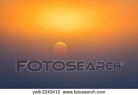 Stock Image - Sun seen thru the fog, Iceland.. Fotosearch