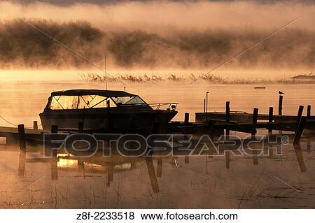 Sunrise mist and boat dock over Lake of the Woods near Warroad Minnesota USA. View Large Photo Image Stock Photo - Sunrise mist and boat dock over Lake of the Woods near Warroad Minnesota USA.. Fotosearch