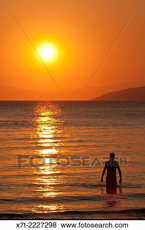 Sunset across the Messinian Gulf at Kalogria beach, Stoupa, in the Outer Mani, Southern Peloponnese, Greece. View Large Photo Image Stock Photo - Sunset across the Messinian Gulf at Kalogria beach, Stoupa, in the Outer Mani, Southern Peloponnese, Greece.. Fotosearch