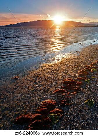 Sunset behind Montsia Hills at Alfacs Bay. Ebro River Delta Natural Park, Tarragona province, Catalonia, Spain. View Large Photo Image Stock Photography - Sunset behind Montsia Hills at Alfacs Bay. Ebro River Delta Natural Park, Tarragona province, Catalonia, Spain.. Fotosearch