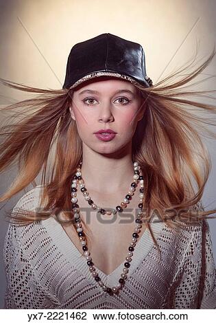 Stock Image - Teenager wearing a leather hat.. Fotosearch