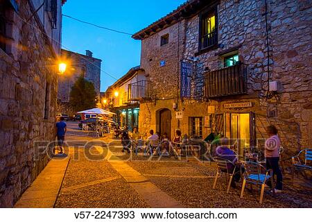 Stock Image - Terraces in Plaza del Trigo, night view. Atienza, Guadalajara province, Castilla La Mancha, Spain.. Fotosearch