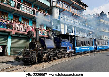 The black steam powered Darjeeling Toy Train approaches in the city. View Large Photo Image Stock Photo - The black steam powered Darjeeling Toy Train approaches in the city.. Fotosearch