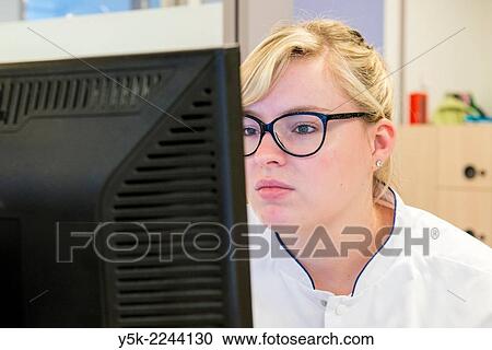 Tilburg, Nederland. Young, blonde nurse, doing her work as a receptionist at the main desk of the orthopedics nursing ward. View Large Photo Image Stock Image - Tilburg, Nederland. Young, blonde nurse, doing her work as a receptionist at the main desk of the orthopedics nursing ward.. Fotosearch