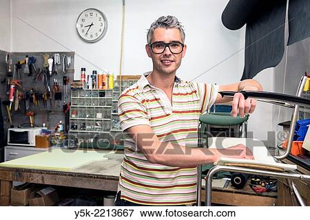 Tilburg, Netherlands. Josef works as an independent upholsterer in his own workshop, down town Tilburg, where he refurbishes and upholsters all kinds of chairs. View Large Photo Image Stock Photo - Tilburg, Netherlands. Josef works as an independent upholsterer in his own workshop, down town Tilburg, where he refurbishes and upholsters all kinds of chairs.. Fotosearch