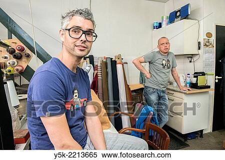 Tilburg, Netherlands. Josef works as an independent upholsterer in his own workshop, down town Tilburg, where he refurbishes and upholsters all kinds of chairs. Every saturday he gets help from his male partner Werner. View Large Photo Image Stock Photography - Tilburg, Netherlands. Josef works as an independent upholsterer in his own workshop, down town Tilburg, where he refurbishes and upholsters all kinds of chairs. Every saturday he gets help from his male partner Werner.. Fotosearch