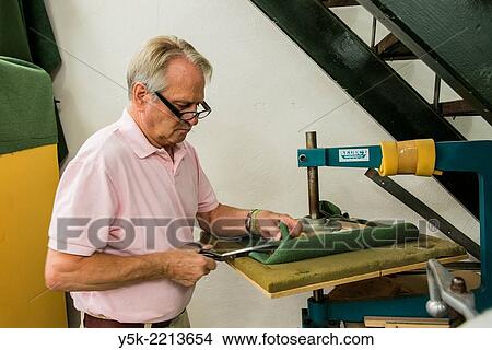 Tilburg, Netherlands. The 72 year old ´Boy´ still works as an independent upholsterer in his own workshop, down town Tilburg, where he refurbishes and upholsters all kinds of chairs. View Large Photo Image Picture - Tilburg, Netherlands. The 72 year old ´Boy´ still works as an independent upholsterer in his own workshop, down town Tilburg, where he refurbishes and upholsters all kinds of chairs.. Fotosearch