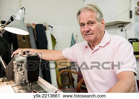 Stock Image - Tilburg, Netherlands. The 72 year old ´Boy´ still works as an independent upholsterer in his own workshop, down town Tilburg, where he refurbishes and upholsters all kinds of chairs.. Fotosearch
