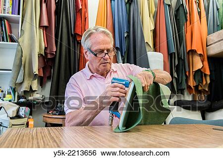Tilburg, Netherlands. The 72 year old ´Boy´ still works as an independent upholsterer in his own workshop, down town Tilburg, where he refurbishes and upholsters all kinds of chairs. View Large Photo Image Stock Photograph - Tilburg, Netherlands. The 72 year old ´Boy´ still works as an independent upholsterer in his own workshop, down town Tilburg, where he refurbishes and upholsters all kinds of chairs.. Fotosearch