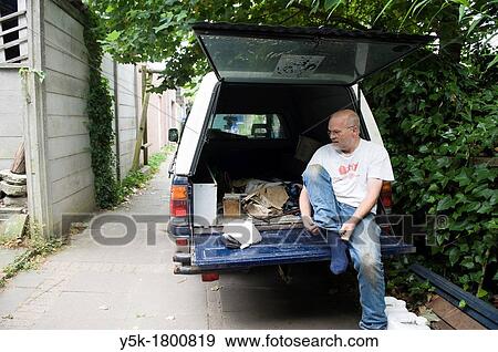 Tilburg, Netherlands. Urban beekeeper preparing to visit his bees. View Large Photo Image Stock Photo - Tilburg, Netherlands. Urban beekeeper preparing to visit his bees.. Fotosearch