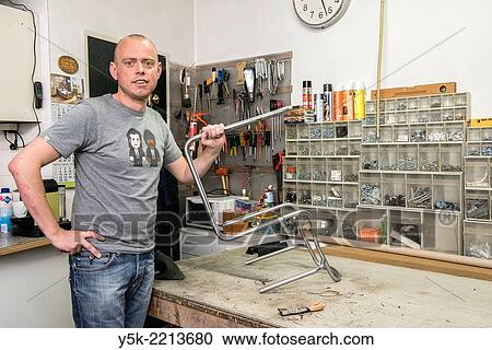 Tilburg, Netherlands. Werner assistes his male partner Josef, who works as an independent upholsterer in his own workshop, down town Tilburg, where he refurbishes and upholsters all kinds of chairs. View Large Photo Image Stock Image - Tilburg, Netherlands. Werner assistes his male partner Josef, who works as an independent upholsterer in his own workshop, down town Tilburg, where he refurbishes and upholsters all kinds of chairs.. Fotosearch
