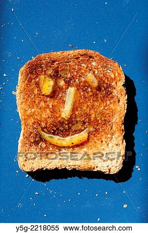 toasted bread with happy marmalade jam face on blue plate in sun View Large Photo Image Stock Photography - toasted bread with happy marmalade jam face on blue plate in sun. Fotosearch