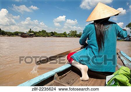 Traditional boats carry freight on the Mekong River and canals near Ben Tre. View Large Photo Image Picture - Traditional boats carry freight on the Mekong River and canals near Ben Tre.. Fotosearch