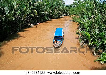 Traditional boats carry freight on the Mekong River and canals near Ben Tre. View Large Photo Image Stock Image - Traditional boats carry freight on the Mekong River and canals near Ben Tre.. Fotosearch