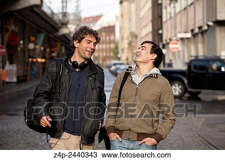 Two students have a funny conversation in the street. View Large Photo Image Stock Image - Two students have a funny conversation in the street.. Fotosearch