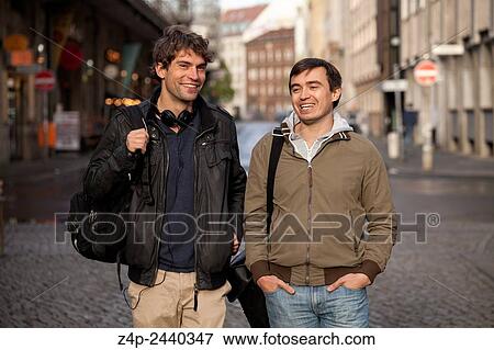 Two young man in a street with smiling face. View Large Photo Image Stock Photo - Two young man in a street with smiling face.. Fotosearch