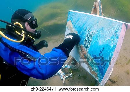 Stock Image - Underwater artist Yuriy Alexeev (Yuri Alekseev) paints a picture under water. Lake Baikal, Listvyanka, Irkutsky District, Irkutsk Oblast, Siberia, Russia, Eurasia.. Fotosearch