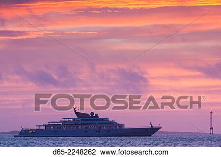 Stock Image - USA, South Carolina, Charleston, yacht in Charleston Harbor, dawn.. Fotosearch