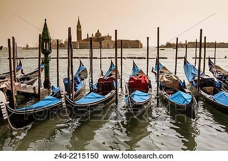 Stock Image - Venetian Gondolas and San Giorgio Maggiore island. San Marco district, Venice, Veneto region, Italy, Europe.. Fotosearch