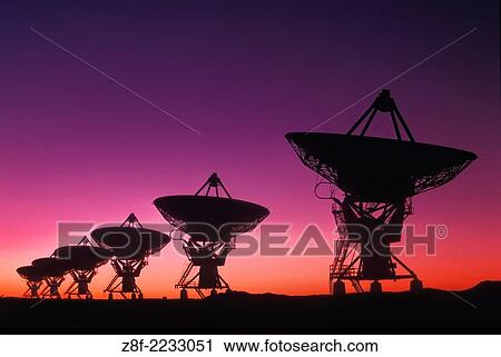 Stock Image - VLA radio telescope array, near Socorro, New Mexico. Antennas in D (closest) configuration This shot taken in the early 1980s. Coloration partly form duo-color polarizing filter. But the scene was an evening twilight shot,.. Fotosearch