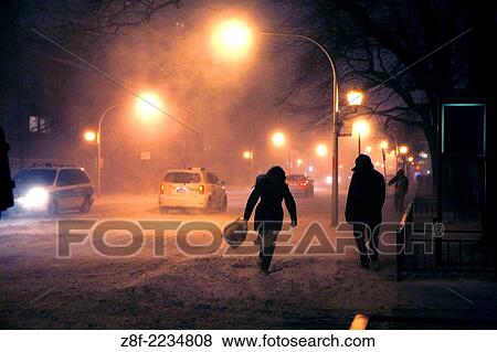 Walking is treacherous facing strong wind and snow. By 6pm very few people ventured out onto the streets of Chicago. View Large Photo Image Stock Photo - Walking is treacherous facing strong wind and snow. By 6pm very few people ventured out onto the streets of Chicago.. Fotosearch