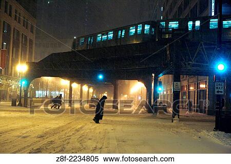Walking is treacherous facing strong wind and snow. By 6pm very few people ventured out onto the streets of Chicago. The EL train kept operating during the blizzard. View Large Photo Image Stock Photography - Walking is treacherous facing strong wind and snow. By 6pm very few people ventured out onto the streets of Chicago. The EL train kept operating during the blizzard.. Fotosearch