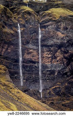 Stock Photography - Waterfalls streaming out of the rocks, Mt. Lomagnupur, Eastern, Iceland.. Fotosearch