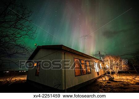 Stock Photo - Winter Icelandic landscape with Northern lights background. Iceland.. Fotosearch